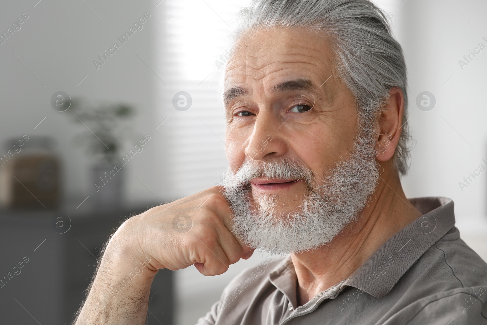 Photo of Portrait of handsome senior man at home