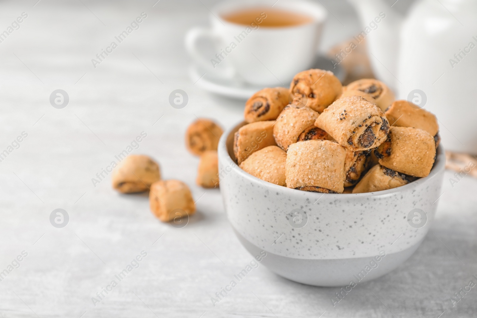 Photo of Tasty sweet cookies with poppy seeds on gray table. Space for text