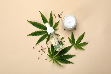 Photo of Flat lay composition with CBD oil or THC tincture and hemp leaves on beige background