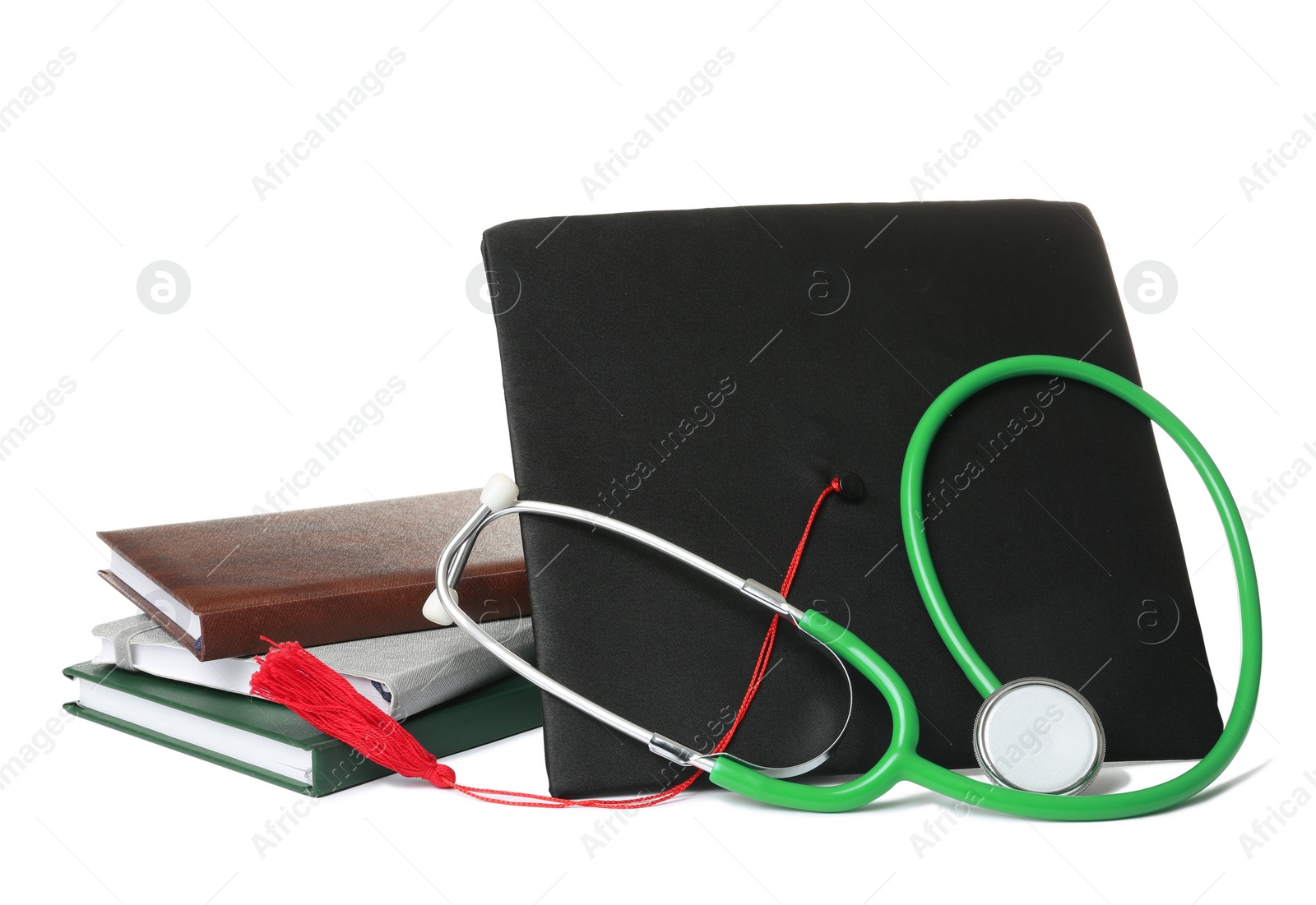 Photo of Stethoscope notebooks and graduation hat on white background. Medical students stuff