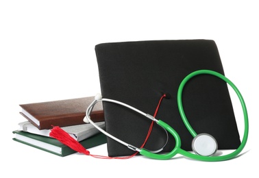 Stethoscope notebooks and graduation hat on white background. Medical students stuff