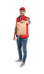 Photo of Young courier with paper bag on white background. Food delivery service