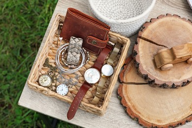 Many different decorative items on wooden table outdoors, top view. Garage sale