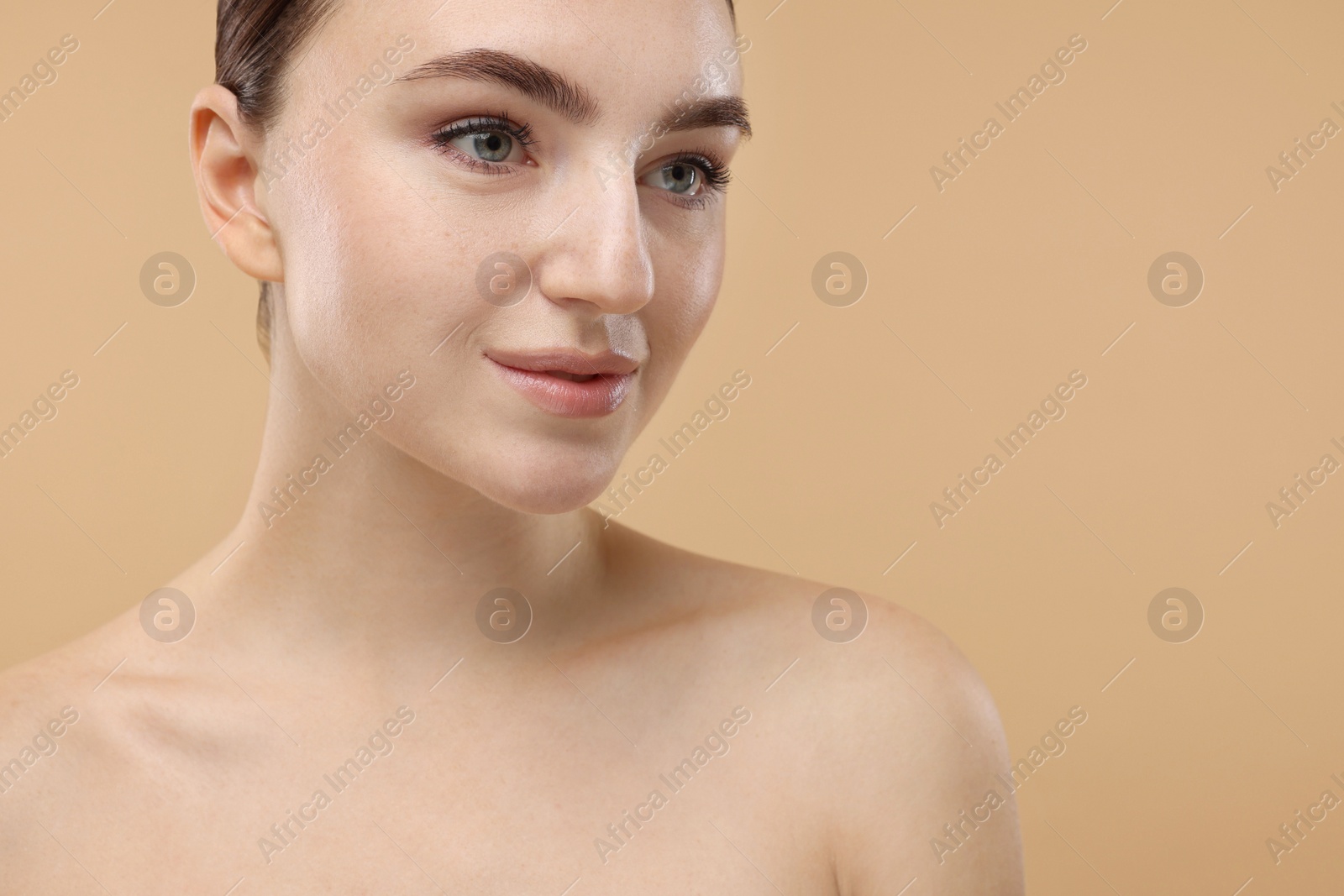 Photo of Portrait of beautiful woman on beige background, closeup. Space for text