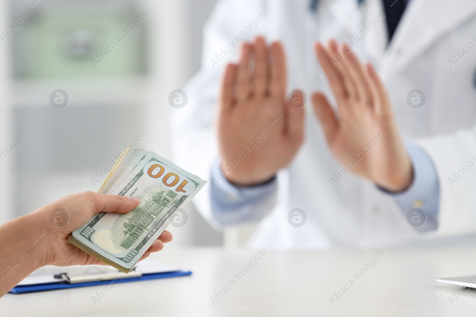 Photo of Doctor rejecting bribe in clinic, closeup. Corrupted medicine