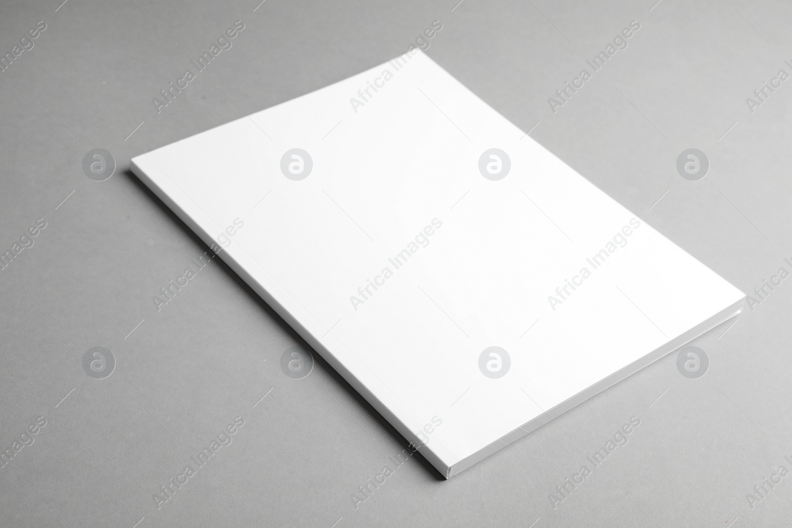 Photo of Brochure with blank cover on grey background. Mock up for design