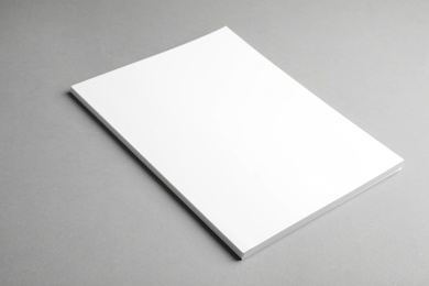 Brochure with blank cover on grey background. Mock up for design