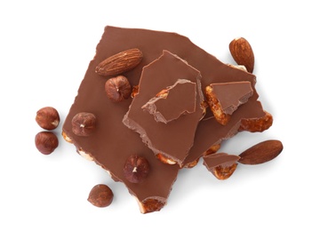 Delicious milk chocolate with nuts on white background, top view