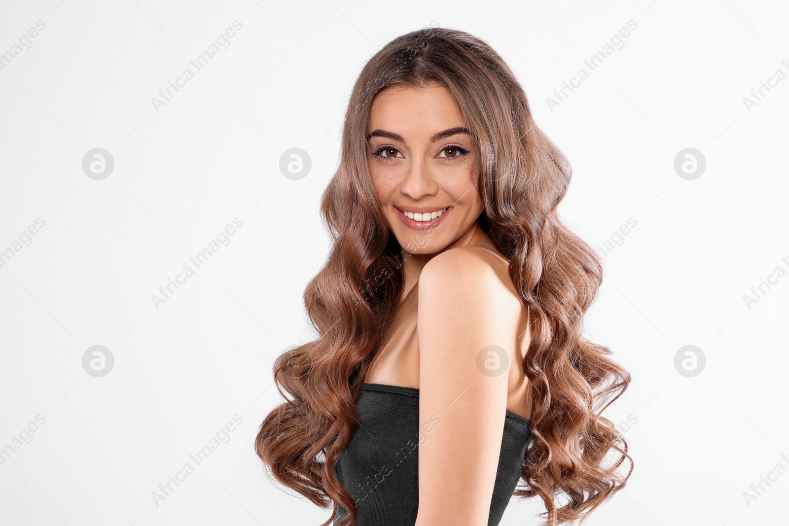 Photo of Beautiful woman with shiny wavy hair on white background