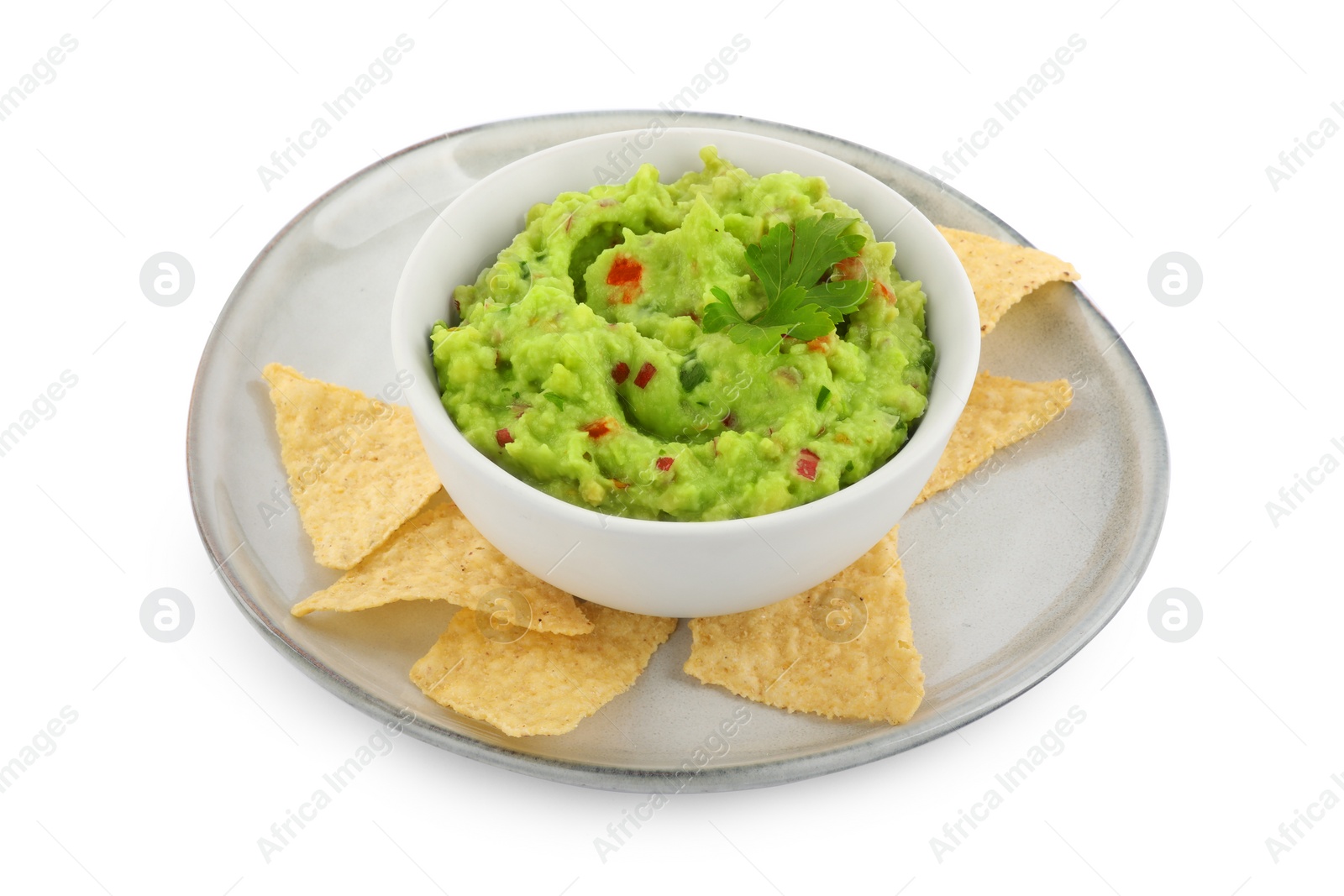 Photo of Delicious guacamole served with nachos chips isolated on white