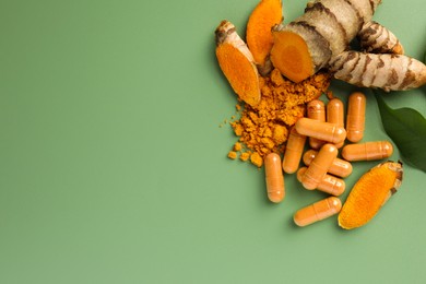 Aromatic turmeric powder, pills and raw roots on green background, flat lay. Space for text