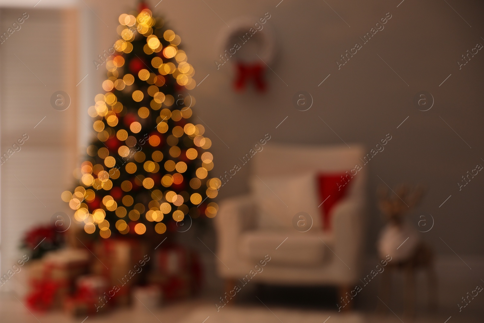 Photo of Blurred view of beautiful decorated Christmas tree in living room