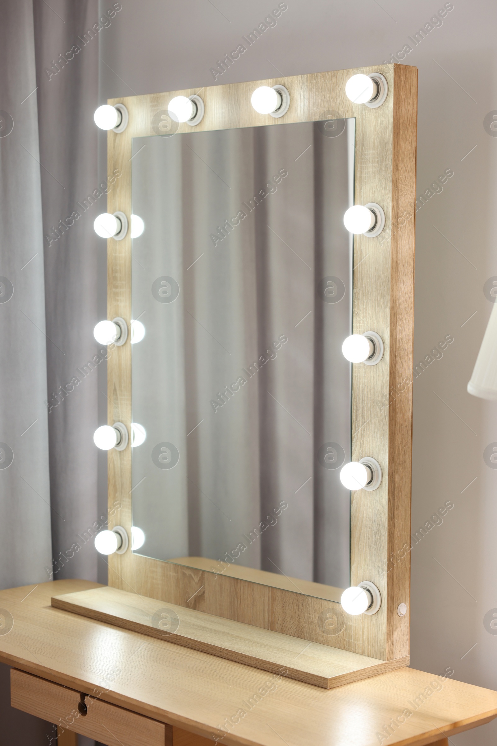 Photo of Beautiful mirror with light bulbs in makeup room