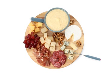 Photo of Fondue with tasty melted cheese, fork and different snacks isolated on white, top view