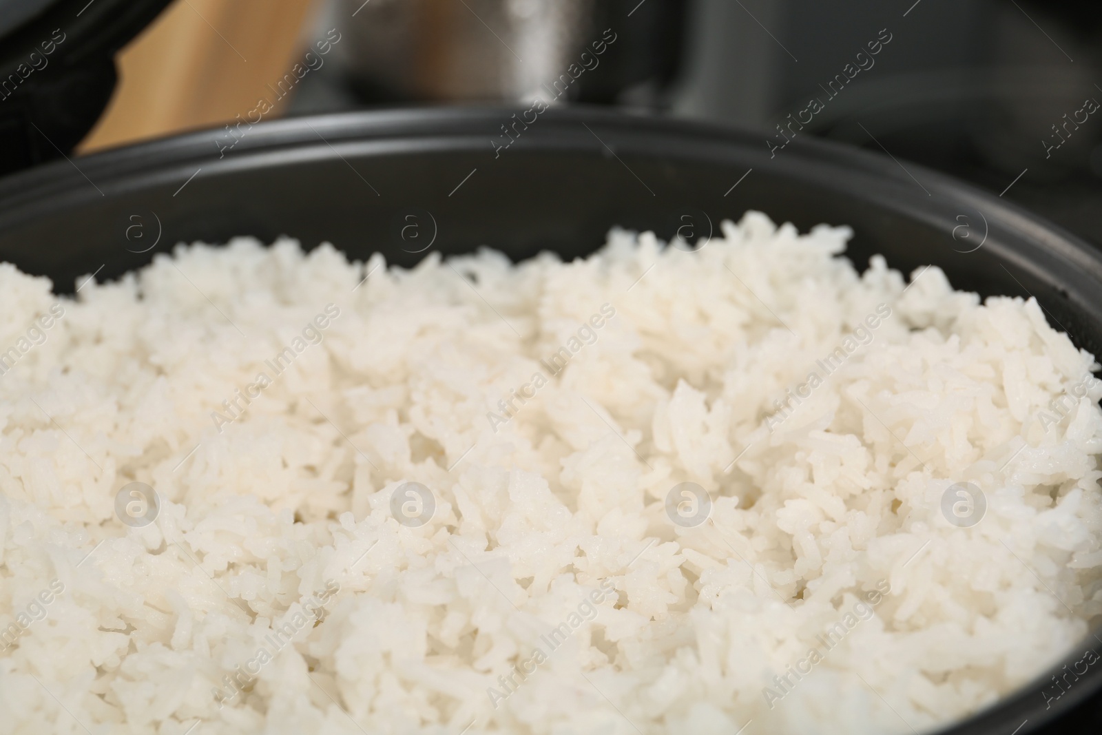 Photo of Modern cooker with fresh boiled rice, closeup