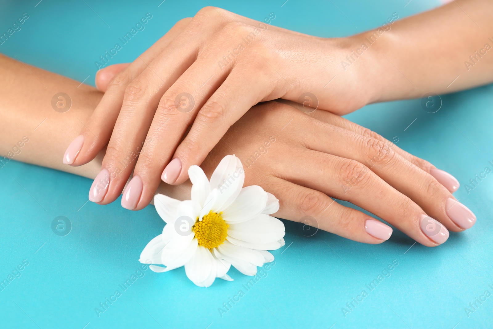 Photo of Closeup view of woman with flower on color background. Spa treatment