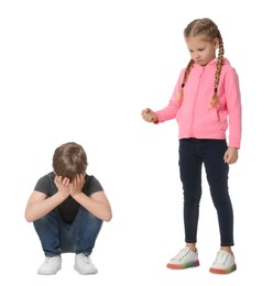 Photo of Girl with clenched fist looking at scared boy on white background. Children's bullying