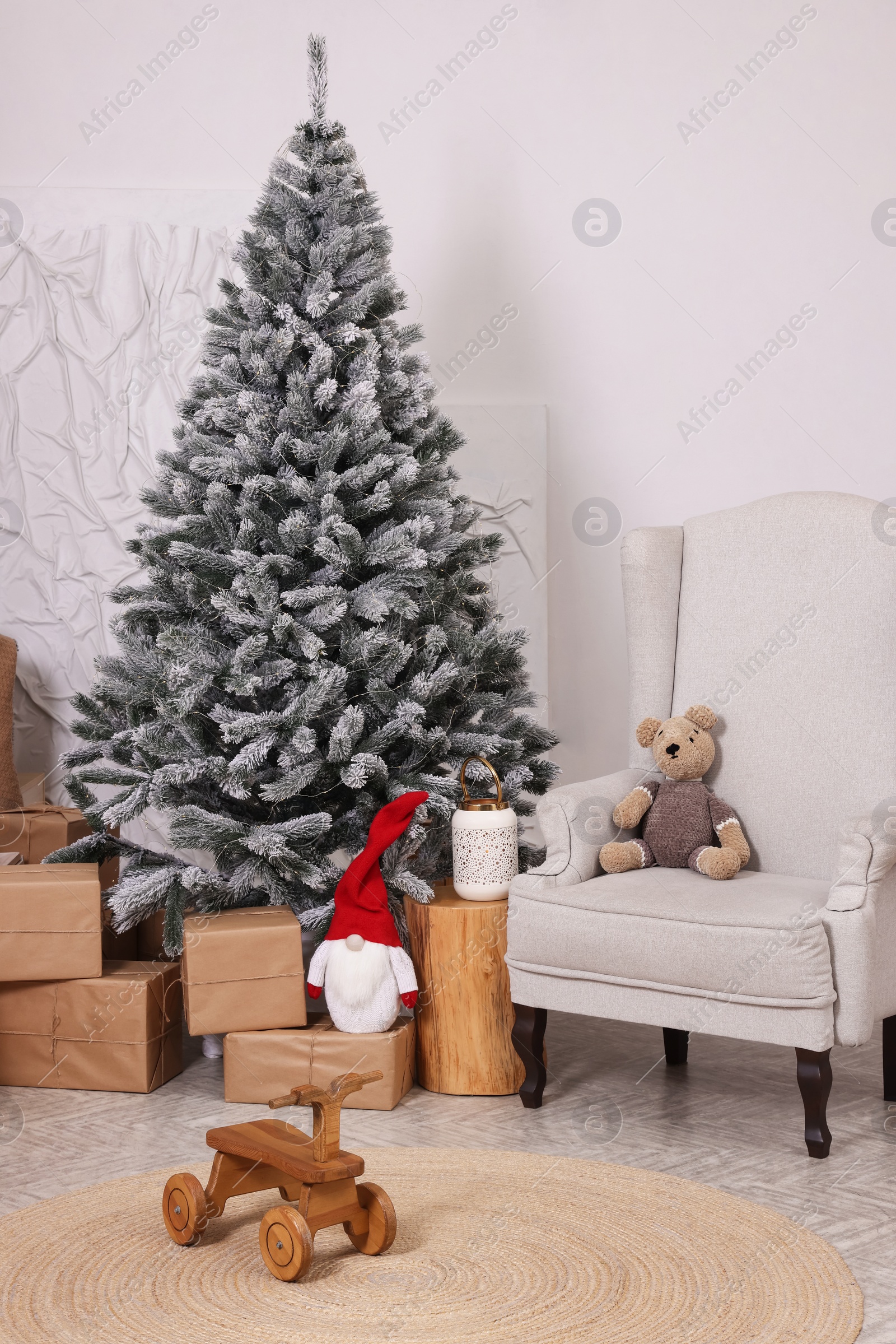 Photo of Stylish room interior with Christmas tree and festive decor