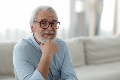 Photo of Portrait of grandpa with stylish glasses indoors, space for text