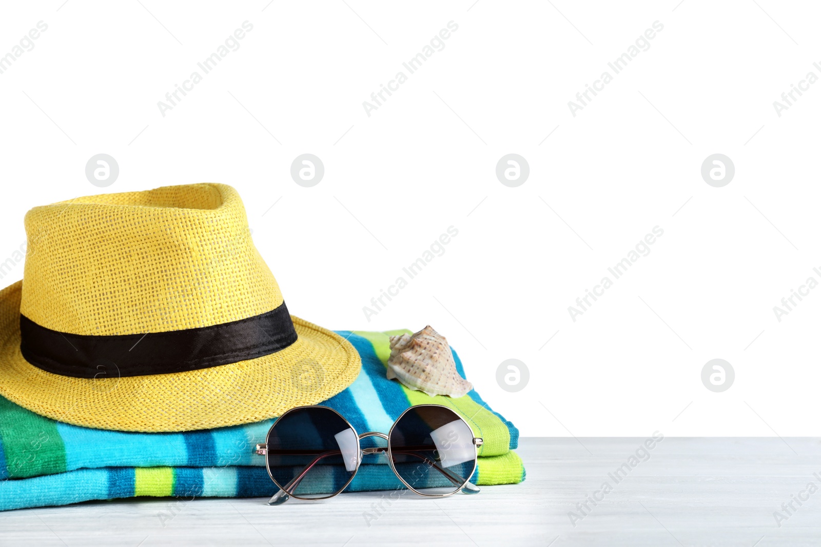 Photo of Composition with different beach objects on light grey wooden table, white background
