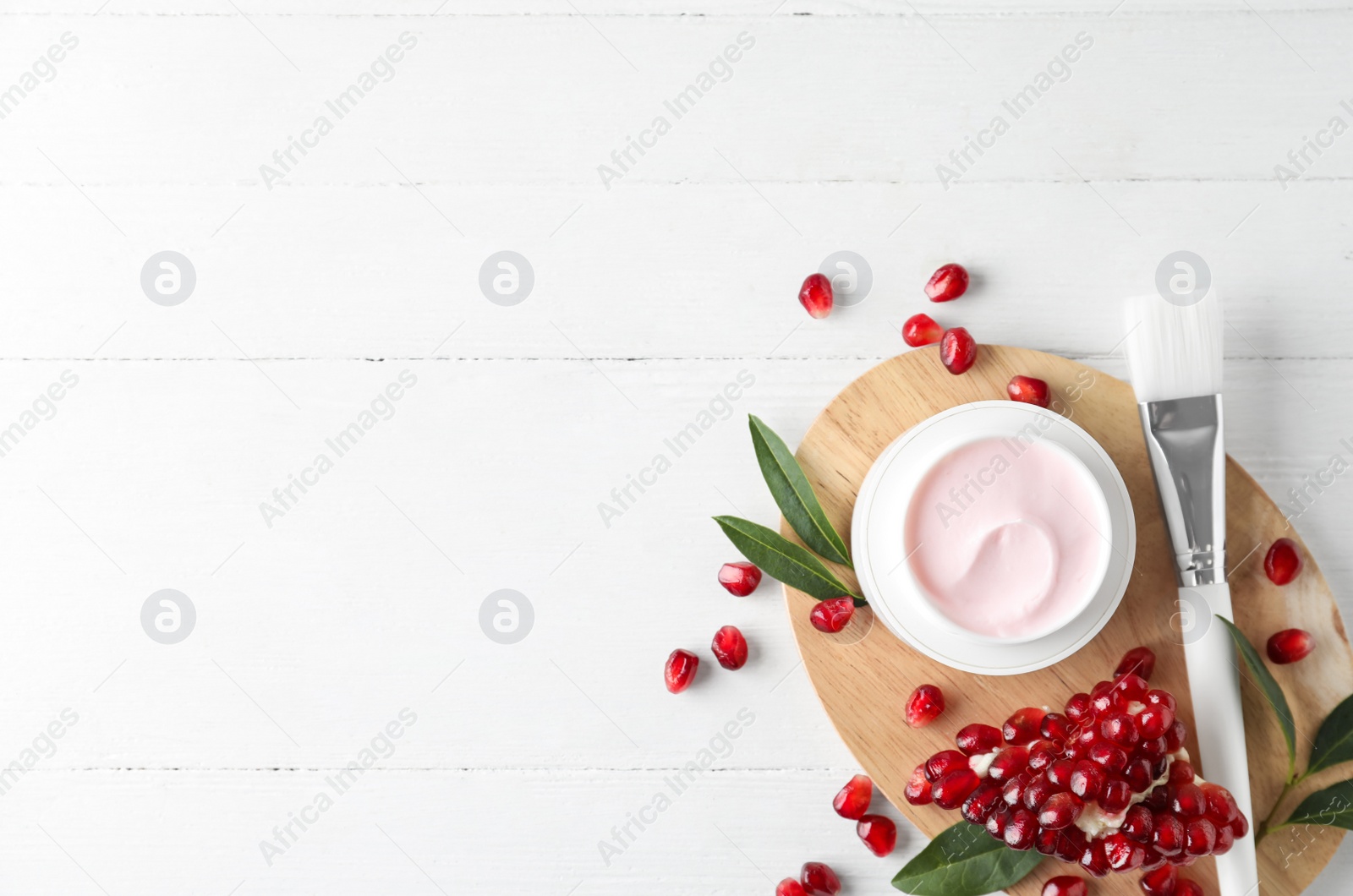 Photo of Flat lay composition with natural pomegranate facial mask on white wooden table. Space for text