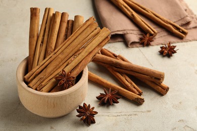 Bowl with cinnamon sticks and star anise on light table