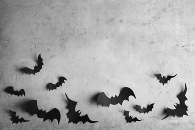 Photo of Paper bats on light grey background, flat lay with space for text. Halloween decor