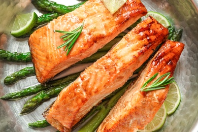 Tasty freshly cooked salmon in frying pan, closeup