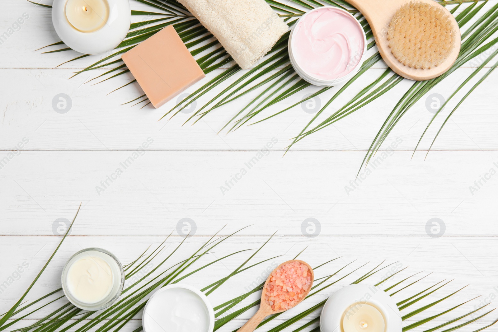 Photo of Flat lay composition with different body care products and space for text on white wooden background