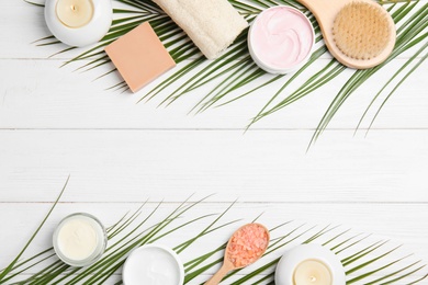 Flat lay composition with different body care products and space for text on white wooden background