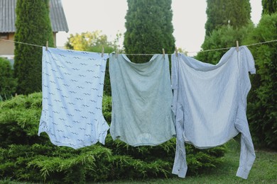 Photo of Shirts drying on washing line at backyard of house