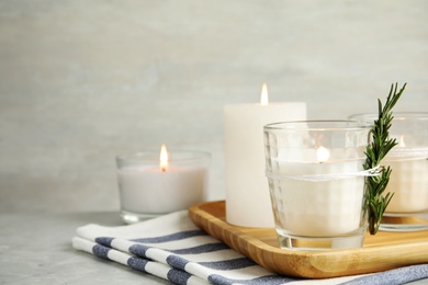 Photo of Beautiful composition with burning candles on table. Space for text