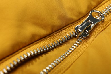 Photo of Yellow jacket with zipper as background, closeup view