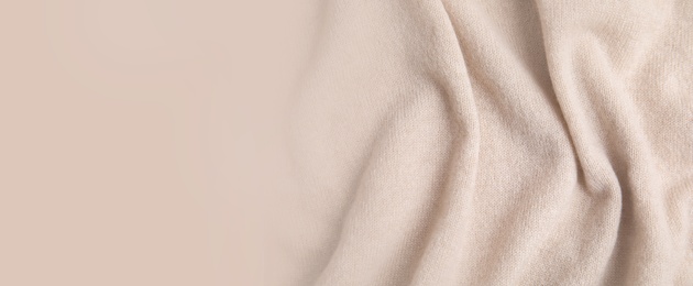 Image of Warm cashmere fabric as background, top view with space for text. Banner design