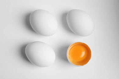 Photo of Fresh raw chicken eggs on white background, flat lay