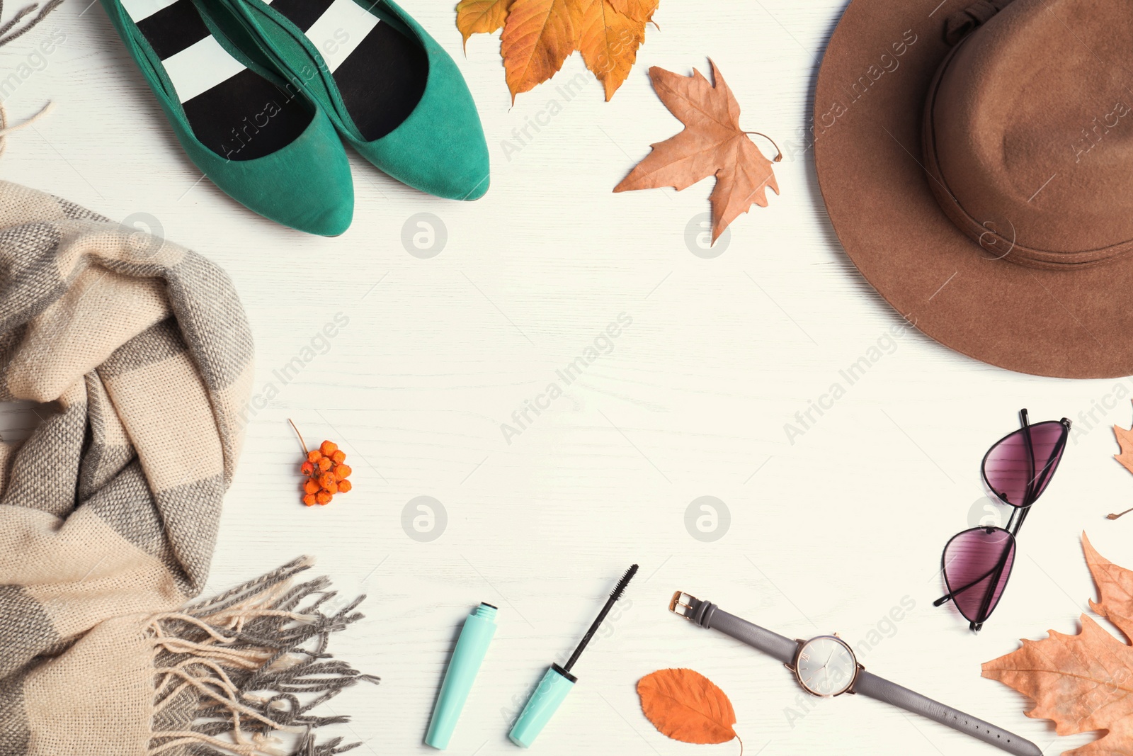 Photo of Stylish outfit and autumn leaves on white wooden background, flat lay with space for text. Trendy warm clothes