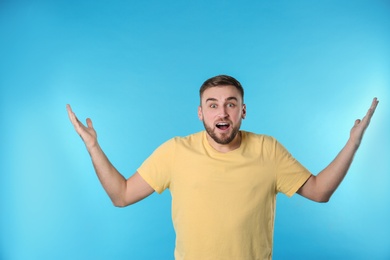 Photo of Portrait of emotional young man on color background