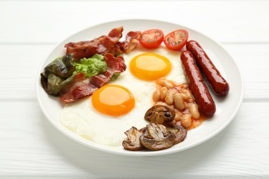 Photo of Delicious breakfast with sunny side up eggs on white wooden table, closeup