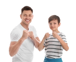 Photo of Portrait of sporty dad and his son isolated on white