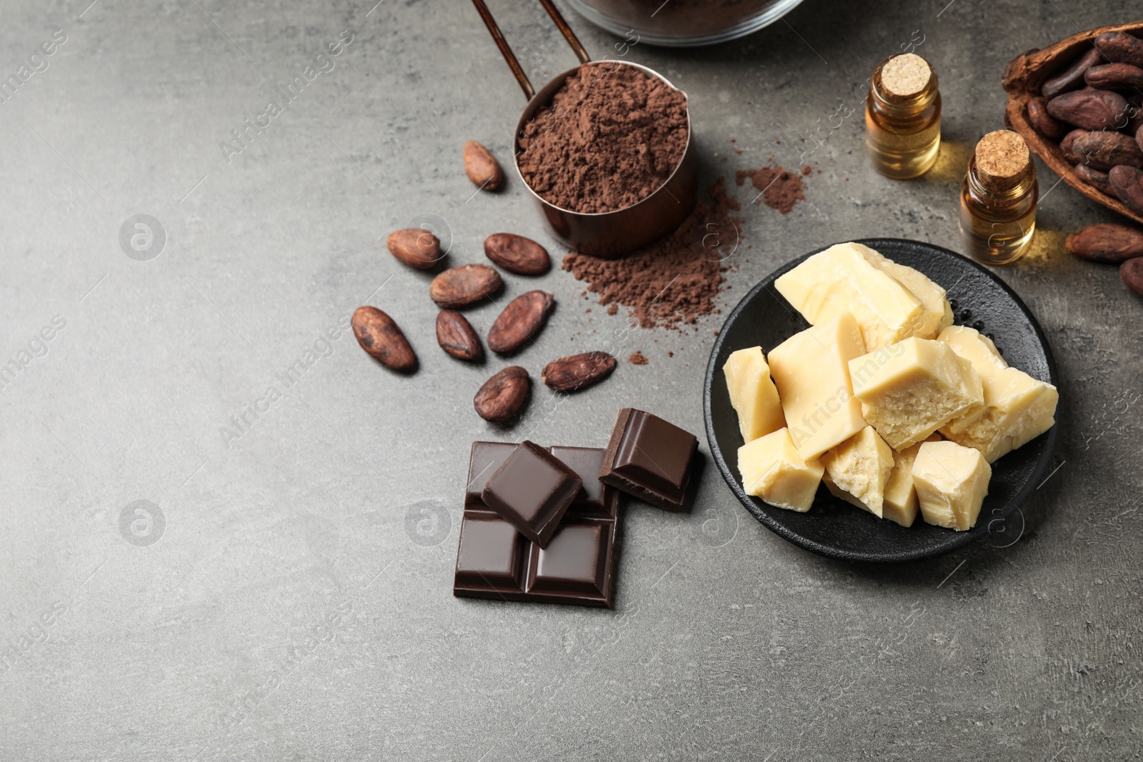 Photo of Organic cocoa butter on grey table, above view