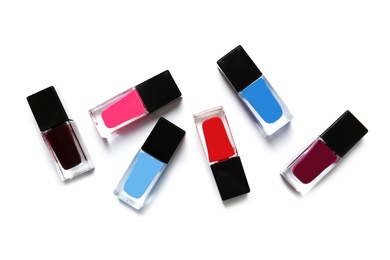 Bottles of nail polish on white background, top view