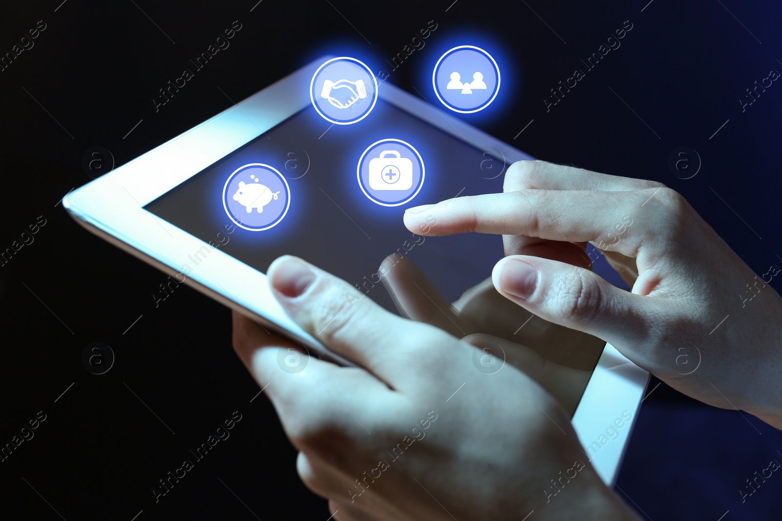 Image of Woman using tablet on dark background, closeup. Insurance concept