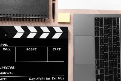 Photo of Flat lay composition with movie clapper on wooden table