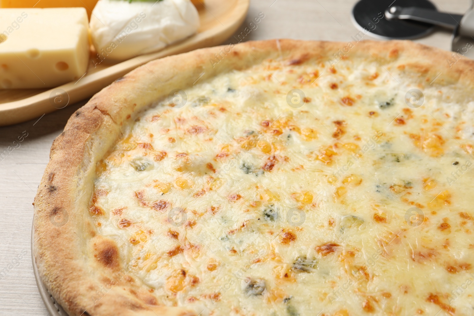 Photo of Delicious cheese pizza on table, closeup view