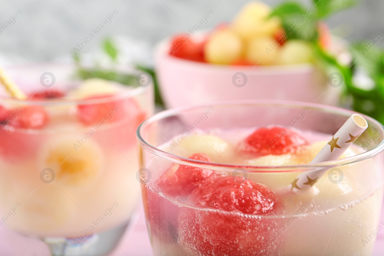 Photo of Glasses of melon and watermelon ball cocktail on table, closeup