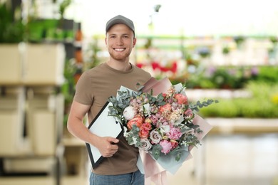 Image of Delivery man with beautiful bouquet in flower shop 