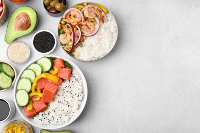 Photo of Poke bowls and ingredients on white table, flat lay. Space for text