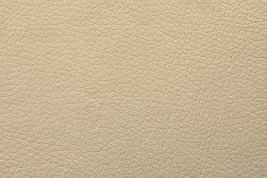 Texture of beige leather as background, closeup