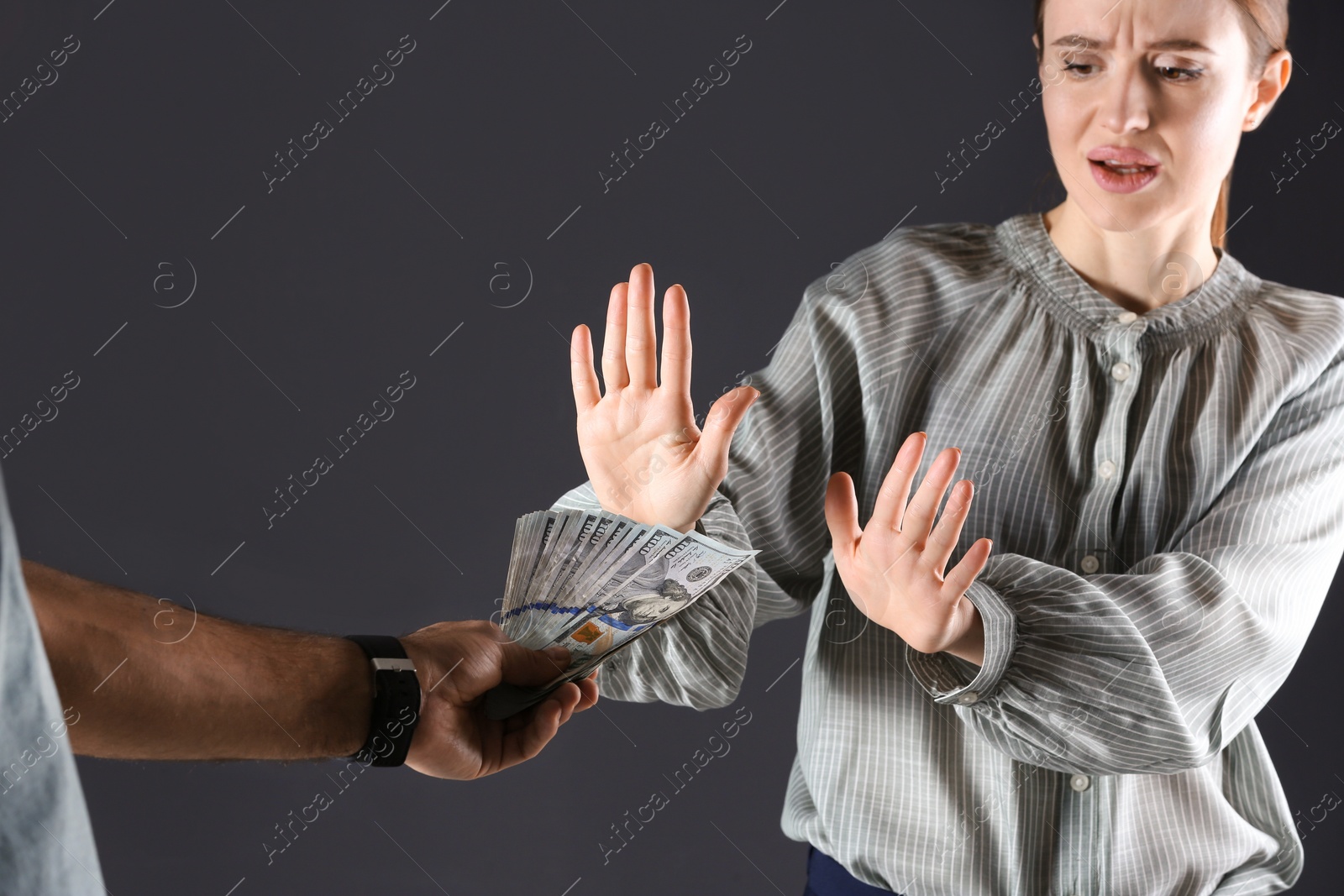 Photo of Woman refusing to take bribe on black background