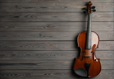Photo of Classic violin on wooden background, top view. Space for text